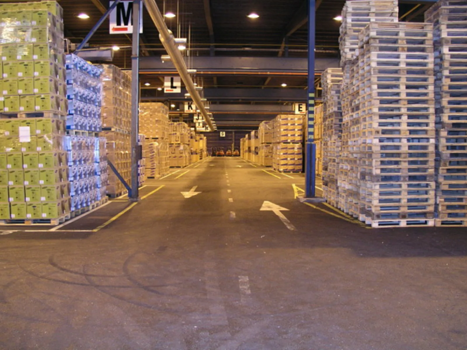 Warehouse aisle stacked with packaged goods on pallets